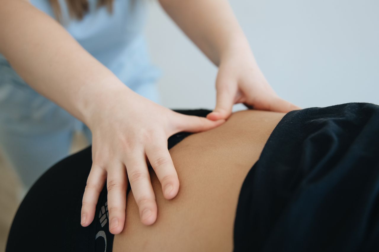digital Close-up of a therapist providing back massage therapy in Vilnius.
